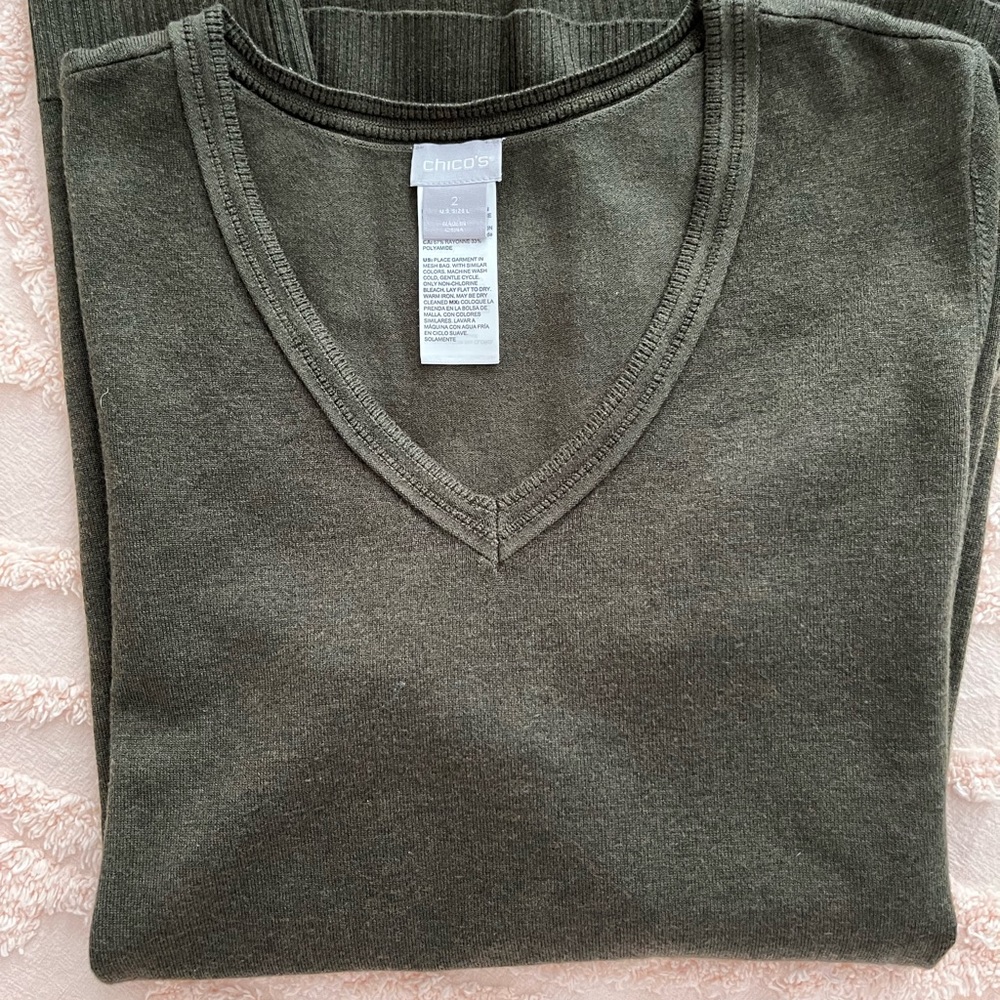 New without tags. Asymmetric style lands below hips. Great cover up.